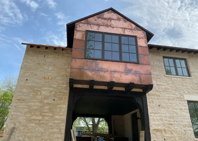 Copper metal panel facade on a stone building for Metal Roof Coating in Staunton